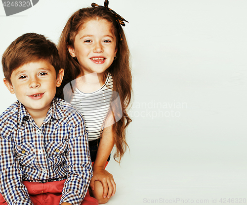 Image of little cute boy and girl hugging playing on white background, ha