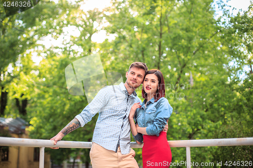 Image of Happy young couple at park standing and laughing on the bright sunny day