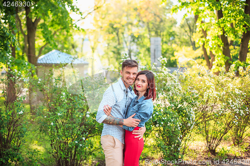 Image of Happy young couple at park standing and laughing on the bright sunny day