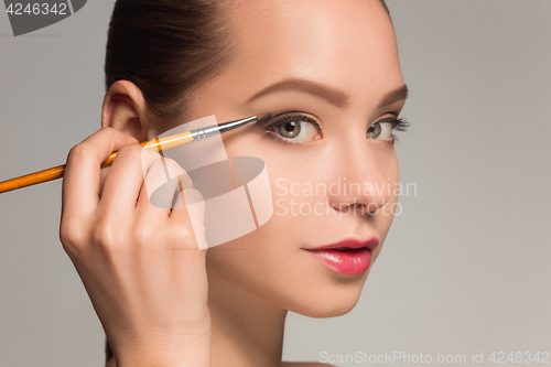 Image of Beautiful female eyes with make-up and brush