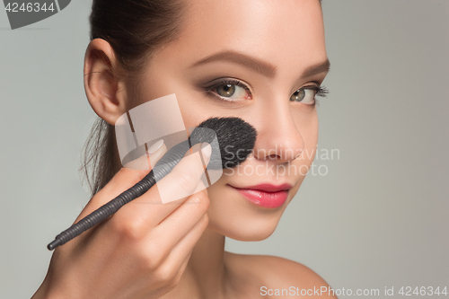 Image of Beautiful female eyes with make-up and brush