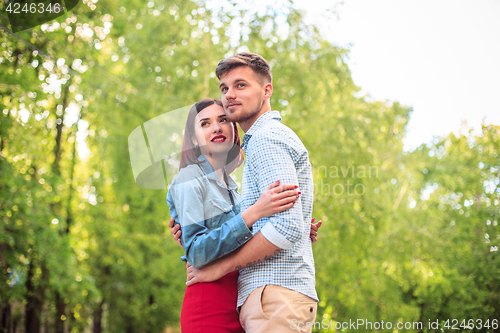 Image of Happy young couple at park standing and laughing on the bright sunny day