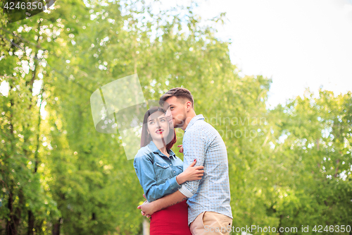 Image of Happy young couple at park standing and laughing on the bright sunny day