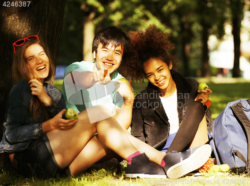 Image of cute group of teenages at the building of university with books 