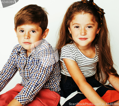 Image of little cute boy and girl hugging playing on white background, ha