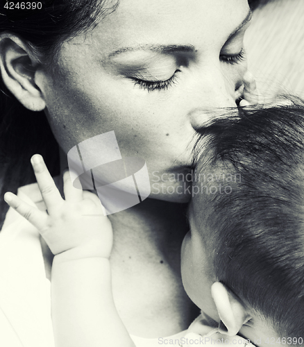 Image of young brunette happy mother holding toddler baby son, breast-feeding concept, lifestyle modern people