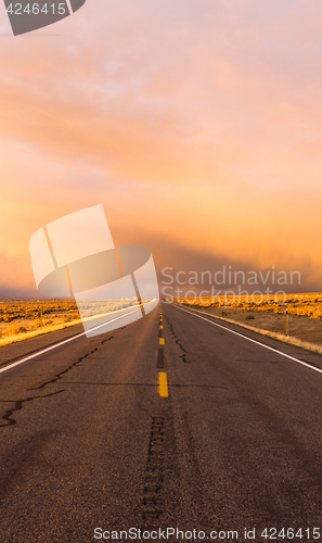 Image of Storm Brews over Two Lane Highway At Sunset