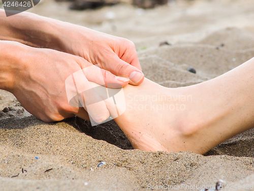 Image of Foot massage on a beach in sand, male and female caucasian