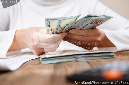 Image of Hands counting money, close up