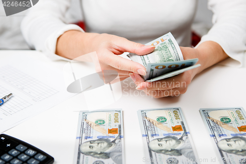 Image of Hands counting money, close up