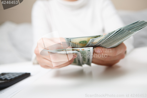 Image of Hands counting money, close up