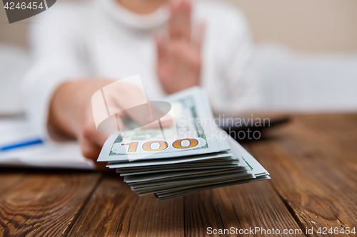 Image of Hands of person proposing money to you - closeup shot