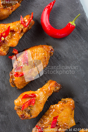 Image of fried chicken wings on a black slate plate 