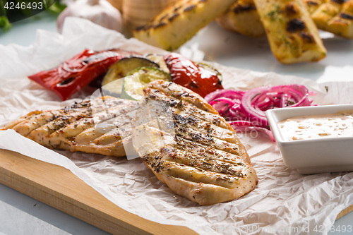 Image of Grilled chicken breast with fries and salad