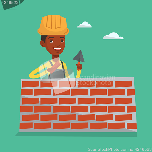 Image of Bricklayer working with spatula and brick.