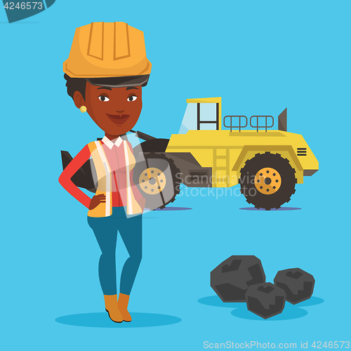 Image of Miner with a big excavator on background.