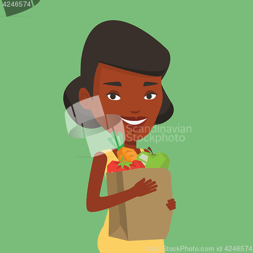 Image of Happy woman holding grocery shopping bag.