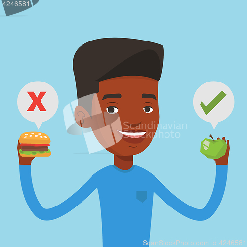 Image of Man choosing between hamburger and cupcake.