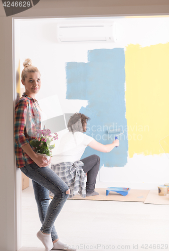 Image of happy young couple doing home renovations