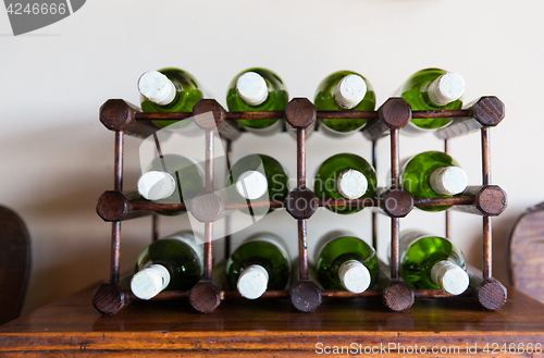 Image of white wine bottles stored on wooden rack