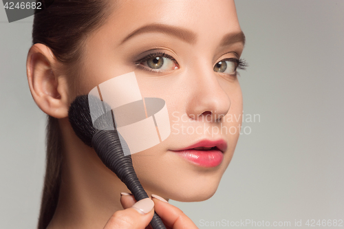 Image of Beautiful female eyes with make-up and brush