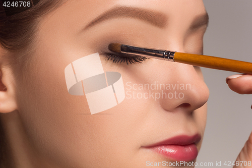 Image of Beautiful female eyes with make-up and brush