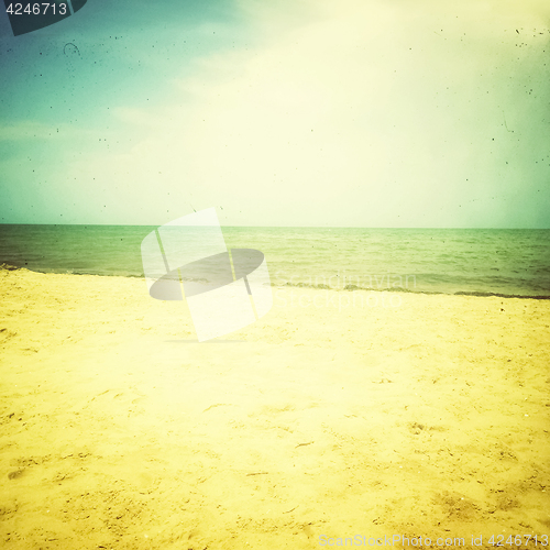 Image of Retro style photo of sea and sand beach