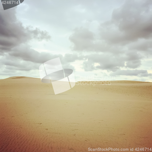 Image of Sand dunes and cloudy sky