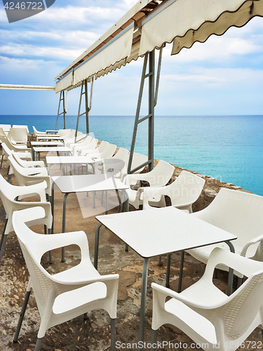 Image of White tables in a cafe by the seaside