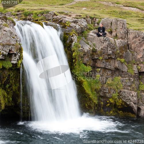 Image of Kirkjufellsfoss waterfall near the Kirkjufell mountain, woman en