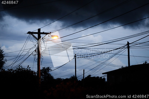 Image of Street light at night with a stormy sky background