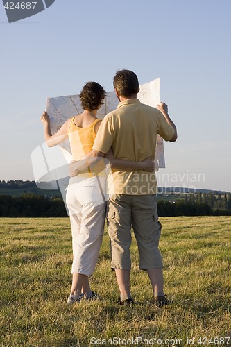 Image of Couple with map in a meadow