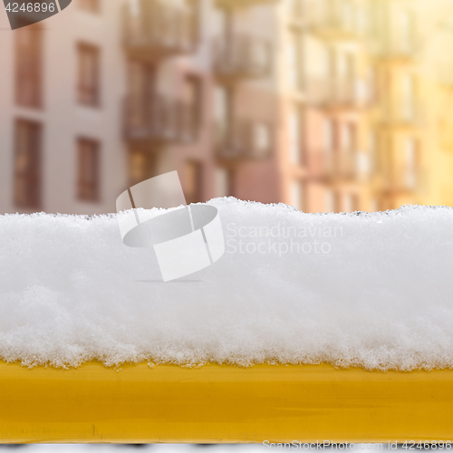 Image of snow on the bench