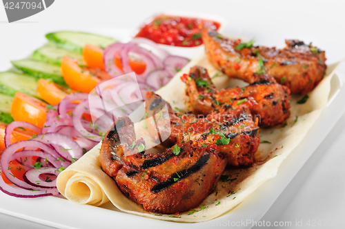 Image of Grilled lamb tongues with fresh vegetables salad