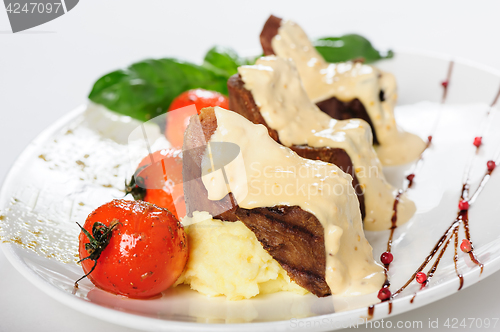 Image of Baked mutton meat with creamy sauce, mashed potato and cherry tomatoes