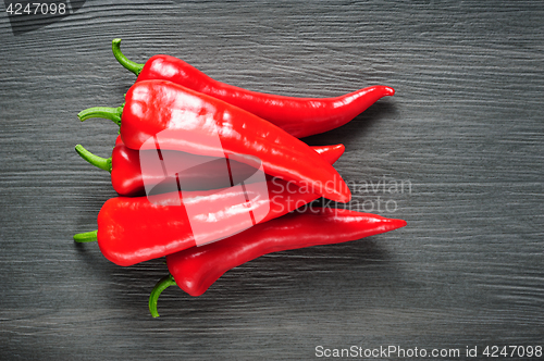 Image of Sweet red Kapia peppers on a dark shale stone background