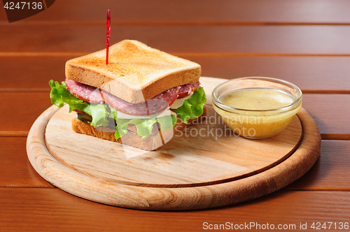 Image of sandvich with cheese, salami and lettuce