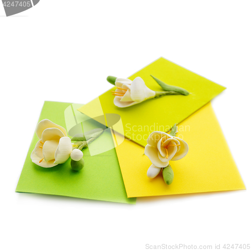 Image of Close up of three yellow envelope with flowers