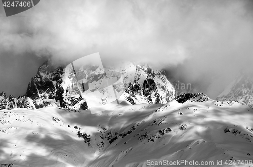 Image of Black and white view on Mount Ushba in fog at sun winter day