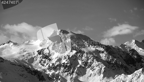 Image of Black and white view on snowy mountains at sun day