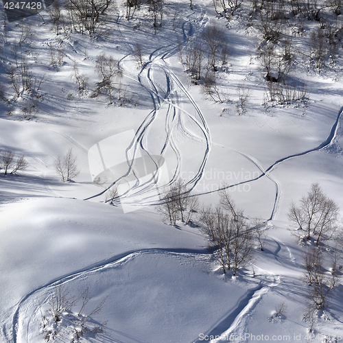 Image of Off-piste slope with track from ski and snowboard at sunny day