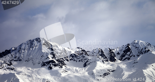 Image of Panoramic view on sunlight winter mountains and sky with clouds