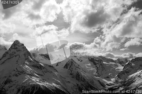 Image of Black and white view on winter snow mountains and cloud sky in e