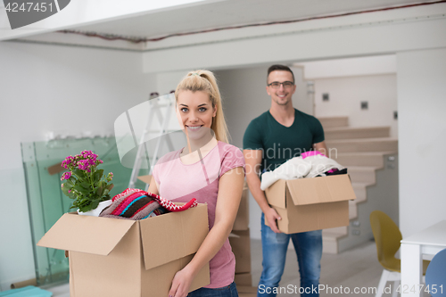 Image of young couple moving into a new home