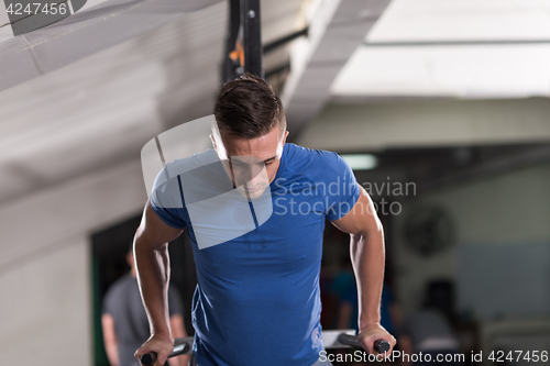 Image of man doing exercises parallel bars