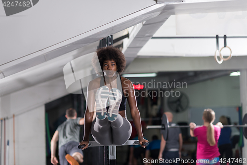 Image of black woman doing parallel bars Exercise