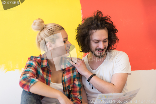 Image of Happy young couple relaxing after painting