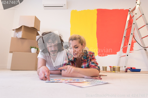 Image of Happy young couple relaxing after painting