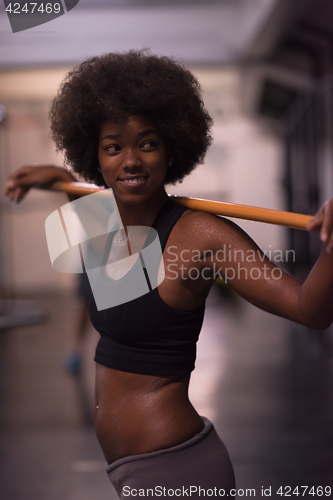 Image of black woman lifting empty bar