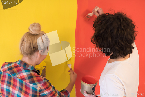 Image of couple painting interior wall